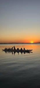 a group of people in a canoe on a lake