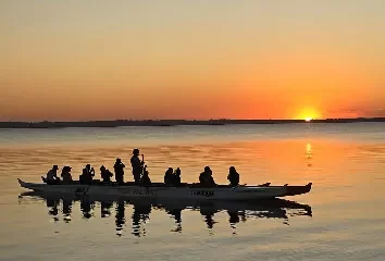 a group of people in a canoe on a lake