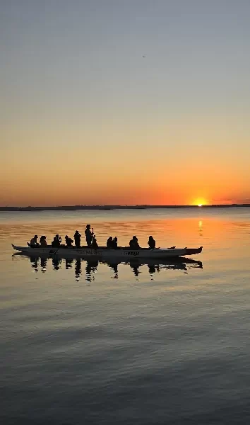 a group of people in a canoe on a lake