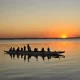 a group of people in a canoe on a lake